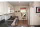 Bright kitchen featuring white cabinets, appliances, and a window with outside view at 1295 Saxony Cir # 2101, Punta Gorda, FL 33983