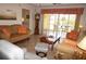 Cozy living room with comfortable seating, tile floors, and a sliding glass door to the screened-in patio at 1295 Saxony Cir # 2101, Punta Gorda, FL 33983