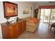 Living room showing a sideboard and sofa with access to outdoor patio at 1295 Saxony Cir # 2101, Punta Gorda, FL 33983