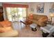 Comfortable living room with tile flooring and a sliding glass door leading to the outdoor patio at 1295 Saxony Cir # 2101, Punta Gorda, FL 33983
