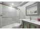 Updated bathroom with modern vanity, frameless mirror, and sliding glass doors enclosing the shower at 1318 Wesley Dr # 7, Punta Gorda, FL 33950