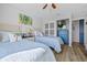 This bedroom features two twin beds with blue quilted bedspreads, wood floors, and ample closet space at 1318 Wesley Dr # 7, Punta Gorda, FL 33950