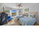 Bright bedroom features two twin beds, wood floors, ceiling fan, and a waterfront view from the window at 1318 Wesley Dr # 7, Punta Gorda, FL 33950