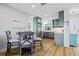 Well-lit kitchen with stylish teal cabinets, stainless steel appliances, and open dining area at 1318 Wesley Dr # 7, Punta Gorda, FL 33950