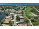 An aerial shot highlights a home's location on a quiet street near a golf course and lake at 13761 Long Lake Ln, Port Charlotte, FL 33953
