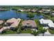 Beautiful lakefront home with lush landscaping and a private driveway, nestled in a serene neighborhood at 13761 Long Lake Ln, Port Charlotte, FL 33953
