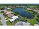 A stunning aerial view of a home with a beautiful lake view, highlighting its prime location and desirable setting at 13761 Long Lake Ln, Port Charlotte, FL 33953