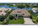 A scenic aerial shot showcases the home's lush landscaping and serene lake views, offering a private and tranquil setting at 13761 Long Lake Ln, Port Charlotte, FL 33953