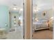A connecting view from the bathroom to the bedroom provides easy access at 13761 Long Lake Ln, Port Charlotte, FL 33953
