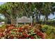 Welcome to Riverwood sign surrounded by flowers and lush landscaping, showing the entrance to the community at 13761 Long Lake Ln, Port Charlotte, FL 33953