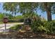 A sign for Fairway Lakes is surrounded by lush landscaping, offering a welcoming entrance to the neighborhood at 13761 Long Lake Ln, Port Charlotte, FL 33953