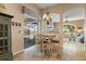 Dining area overlooking the lanai with a chandelier at 13761 Long Lake Ln, Port Charlotte, FL 33953