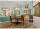 Chic dining room featuring a chandelier, mirror accent wall, and a hutch at 13761 Long Lake Ln, Port Charlotte, FL 33953