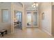 Elegant foyer with a chandelier and a view into the office at 13761 Long Lake Ln, Port Charlotte, FL 33953