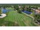 Beautiful aerial view of the golf course with lush greens and water features, offering stunning recreational space at 13761 Long Lake Ln, Port Charlotte, FL 33953