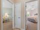 Hallway with a view into two bedrooms, each with unique decor and comfortable furnishings at 13761 Long Lake Ln, Port Charlotte, FL 33953