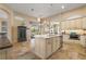 Spacious kitchen with a central island, stainless steel appliances, and tiled floors at 13761 Long Lake Ln, Port Charlotte, FL 33953