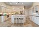 Spacious kitchen featuring custom white cabinetry, a center island, and high-end appliances at 13761 Long Lake Ln, Port Charlotte, FL 33953
