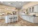 Bright kitchen featuring white cabinets, a large island with seating, and stainless steel appliances at 13761 Long Lake Ln, Port Charlotte, FL 33953