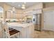 Kitchen with white cabinetry, a large island with seating, and stainless steel refrigerator at 13761 Long Lake Ln, Port Charlotte, FL 33953