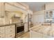 Well-equipped kitchen featuring stainless steel appliances, granite counters and white cabinetry at 13761 Long Lake Ln, Port Charlotte, FL 33953