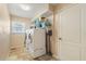Functional laundry room with modern washer and dryer, storage shelves, and a window at 13761 Long Lake Ln, Port Charlotte, FL 33953