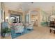Spacious living room with access to the patio and a seamless flow to the kitchen and dining area at 13761 Long Lake Ln, Port Charlotte, FL 33953