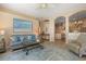 Living room with comfortable seating and an archway to the kitchen and dining room at 13761 Long Lake Ln, Port Charlotte, FL 33953