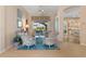 Cozy living room with hardwood floors, floral furniture, and view of the backyard pool at 13761 Long Lake Ln, Port Charlotte, FL 33953
