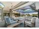 Outdoor patio area complete with furniture, fire pit, and scenic views of the pool at 13761 Long Lake Ln, Port Charlotte, FL 33953