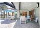 Inviting outdoor patio with comfortable seating, dining area, and view of the pool and house at 13761 Long Lake Ln, Port Charlotte, FL 33953