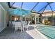 Picturesque backyard pool area with outdoor dining and seating, perfect for entertaining at 13761 Long Lake Ln, Port Charlotte, FL 33953