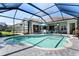 Backyard swimming pool surrounded by a screened enclosure, offering privacy and enjoyment at 13761 Long Lake Ln, Port Charlotte, FL 33953