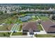 Aerial view of community clubhouse, tennis courts, and bocce ball, offering diverse recreational facilities at 13761 Long Lake Ln, Port Charlotte, FL 33953
