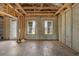 Unfinished basement featuring exposed beams and concrete walls with two windows for renovation at 15345 Pottstown Ave, Port Charlotte, FL 33981