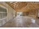 Spacious unfinished basement featuring exposed beams, concrete walls, tile floors, and back door access at 15345 Pottstown Ave, Port Charlotte, FL 33981