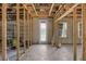 Unfinished basement featuring exposed beams, concrete walls, and a back door for renovation at 15345 Pottstown Ave, Port Charlotte, FL 33981