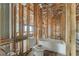 Bathroom features wooden framing, rough-in plumbing, a soaking tub and toilet awaiting final touches and personalization at 15345 Pottstown Ave, Port Charlotte, FL 33981