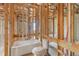 Bathroom with framing, featuring a soaking tub and toilet, ready for customization and finishing touches at 15345 Pottstown Ave, Port Charlotte, FL 33981