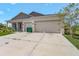 Charming single-story home showcasing a two-car garage and neutral-toned exterior at 15345 Pottstown Ave, Port Charlotte, FL 33981