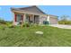 Charming single-story home with a well-maintained lawn, red shutters, and a front-facing two car garage at 15345 Pottstown Ave, Port Charlotte, FL 33981
