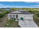 One story home featuring a two-car garage, a front yard, and well-maintained landscaping at 15345 Pottstown Ave, Port Charlotte, FL 33981