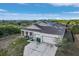 Two-story home featuring a three-car garage and a well-maintained roof at 15345 Pottstown Ave, Port Charlotte, FL 33981
