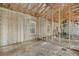 Unfinished garage area features two garage doors, block walls, wooden framing, and ample space for storage at 15345 Pottstown Ave, Port Charlotte, FL 33981
