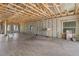 Expansive living room featuring block walls, wooden framing, and large windows providing ample natural light at 15345 Pottstown Ave, Port Charlotte, FL 33981