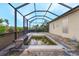 Enclosed pool with screened cage for outdoor enjoyment at 15345 Pottstown Ave, Port Charlotte, FL 33981