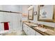 Bright bathroom features a glass shower, double sink vanity with granite counters, and warm gold-toned fixtures at 1673 Palace Ct, Punta Gorda, FL 33980