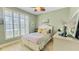 This cozy bedroom features a window with shutters, green walls, and a ceiling fan at 1673 Palace Ct, Punta Gorda, FL 33980
