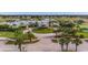 Beautiful clubhouse with lush landscaping, palm trees, and ample parking in a golf community at 1673 Palace Ct, Punta Gorda, FL 33980