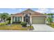 Charming home with a well-manicured lawn, lovely landscaping, and an attached garage at 1673 Palace Ct, Punta Gorda, FL 33980